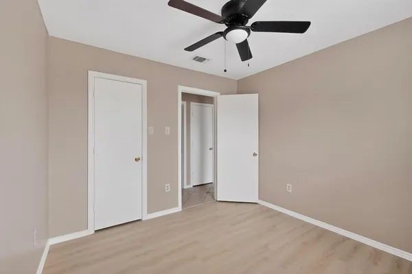 en empty room with ceiling fan and a ceiling fan