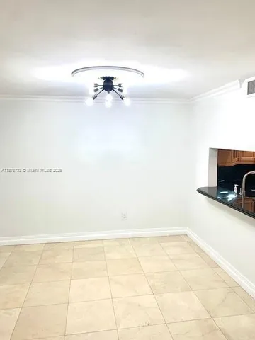a view of a small space with wooden floor and a chandelier
