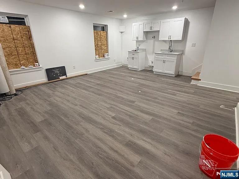 715 South 17th Street Newark, NJ 07103 - Photo 4 of 10 a view of kitchen and empty room with wooden floor