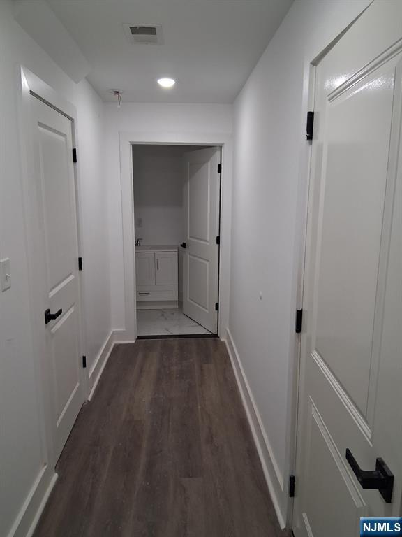 715 South 17th Street Newark, NJ 07103 - Photo 5 of 10 a view of a hallway with wooden floor and closet area