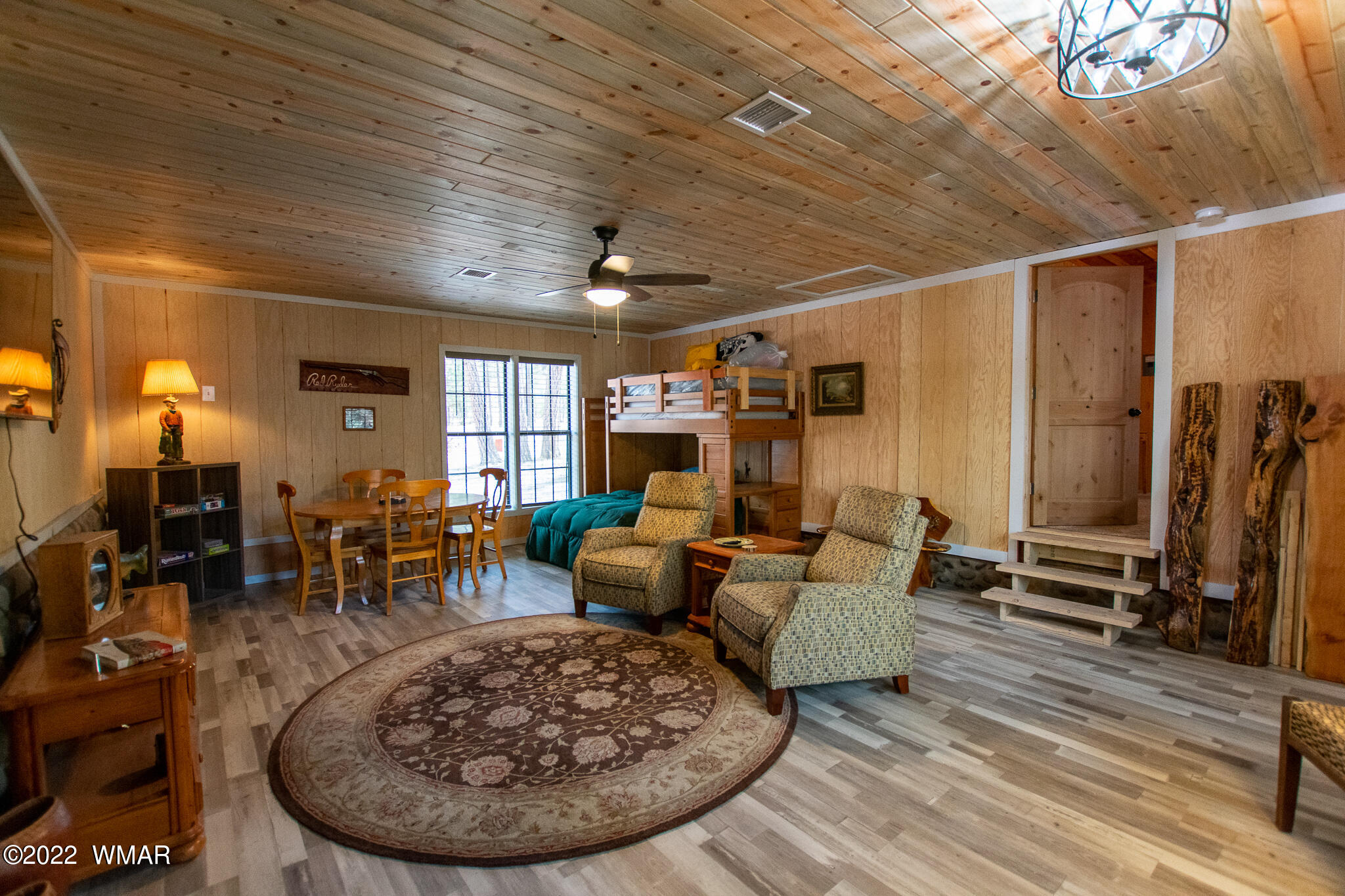 2870 Markham Road Overgaard, AZ 85933 - Photo 8 of 32 a living room with furniture a large window and wooden floor