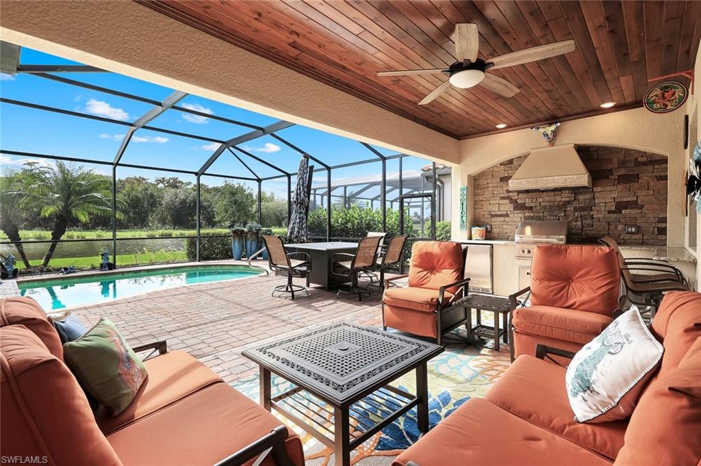 12832 Kinross Lane Naples, FL 34120 - Photo 1 of 44 a outdoor living space with patio furniture and a floor to ceiling window