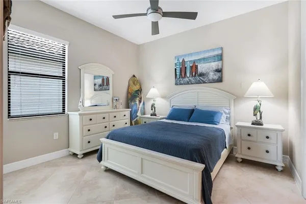 a living room with a bed and a dresser