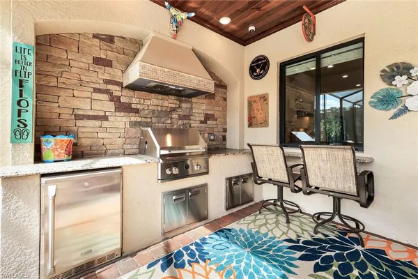 a open kitchen with a stove and white cabinets