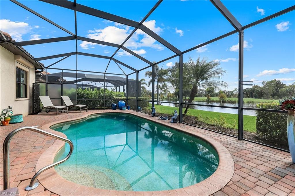 12832 Kinross Lane Naples, FL 34120 - Photo 20 of 44 a view of a swimming pool with a patio