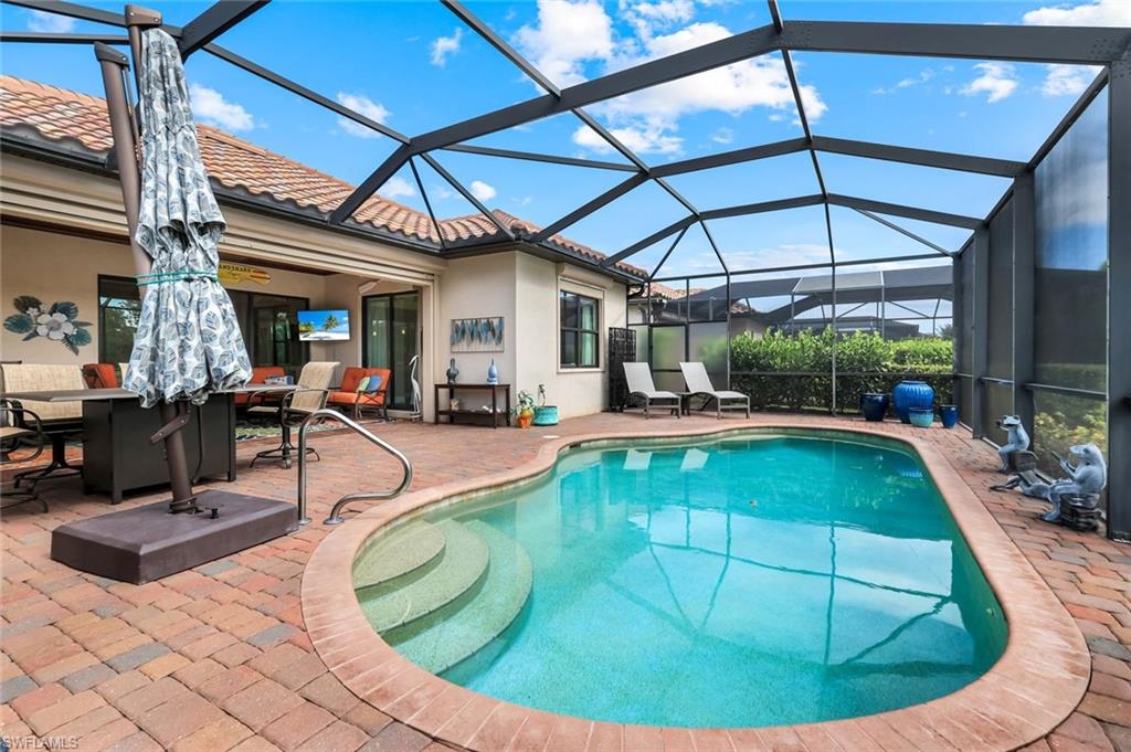 12832 Kinross Lane Naples, FL 34120 - Photo 23 of 44 a view of a swimming pool with a patio