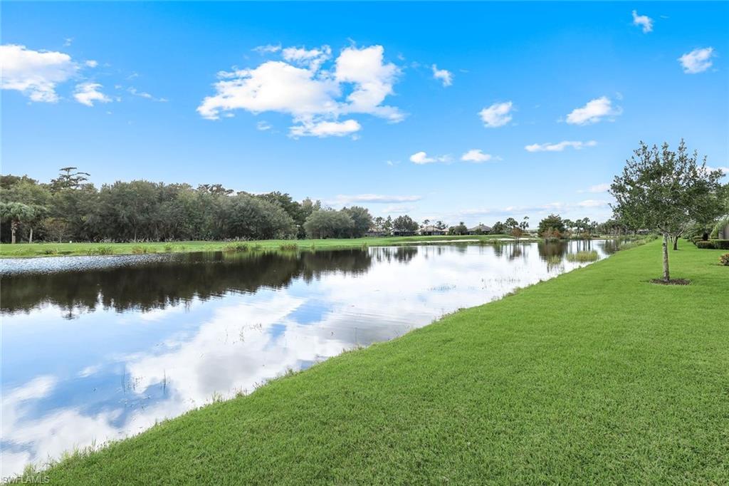 12832 Kinross Lane Naples, FL 34120 - Photo 24 of 44 a view of a lake with a city