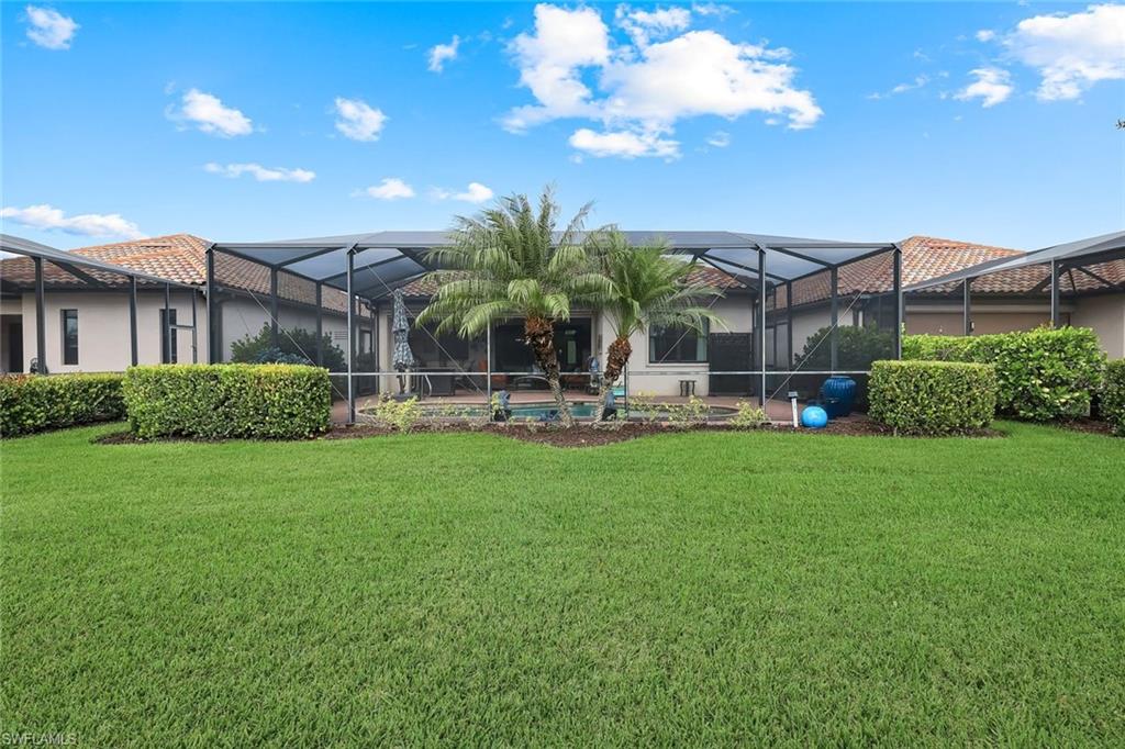 12832 Kinross Lane Naples, FL 34120 - Photo 25 of 44 a view of a house with a backyard and a patio