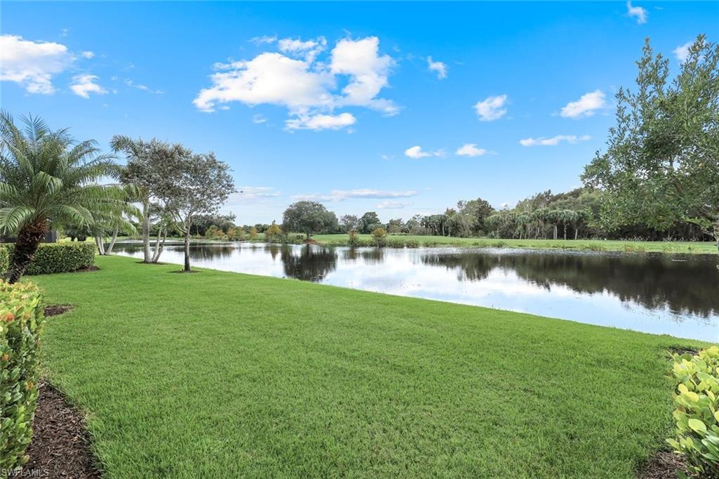 12832 Kinross Lane Naples, FL 34120 - Photo 26 of 44 a view of a lake with a big yard and potted plants