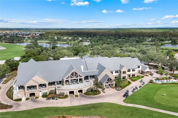 an aerial view of a house with a garden and lake view