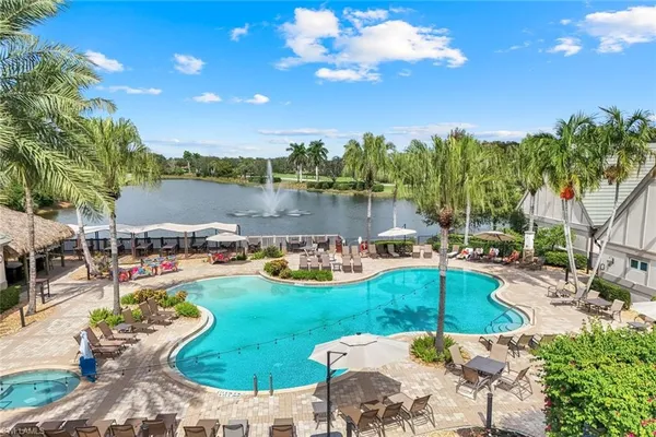 a view of a lake with couches and chairs