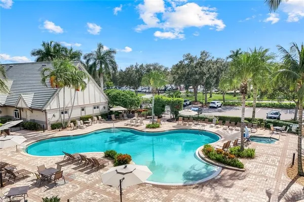 a view of a swimming pool with a patio and plants