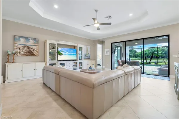 a living room with furniture and large windows