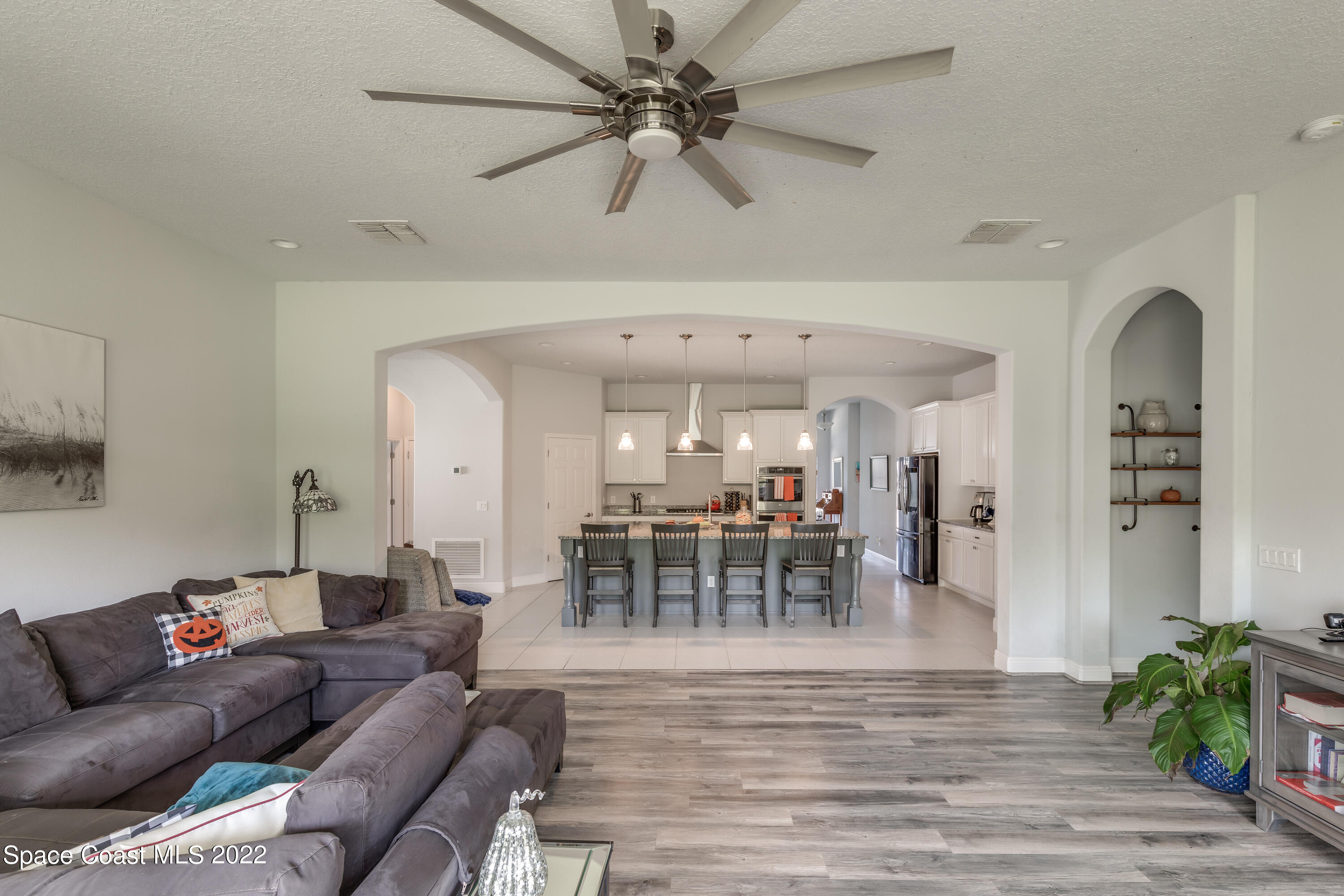4202 Ruthann Circle Melbourne, FL 32934 - Photo 6 of 22 a living room with furniture and a chandelier