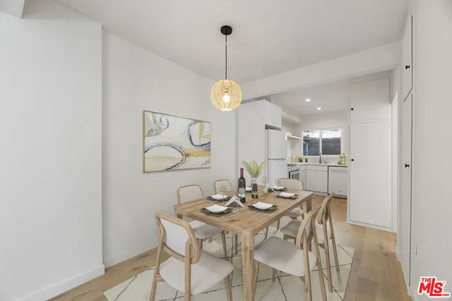 a dining room with furniture and wooden floor