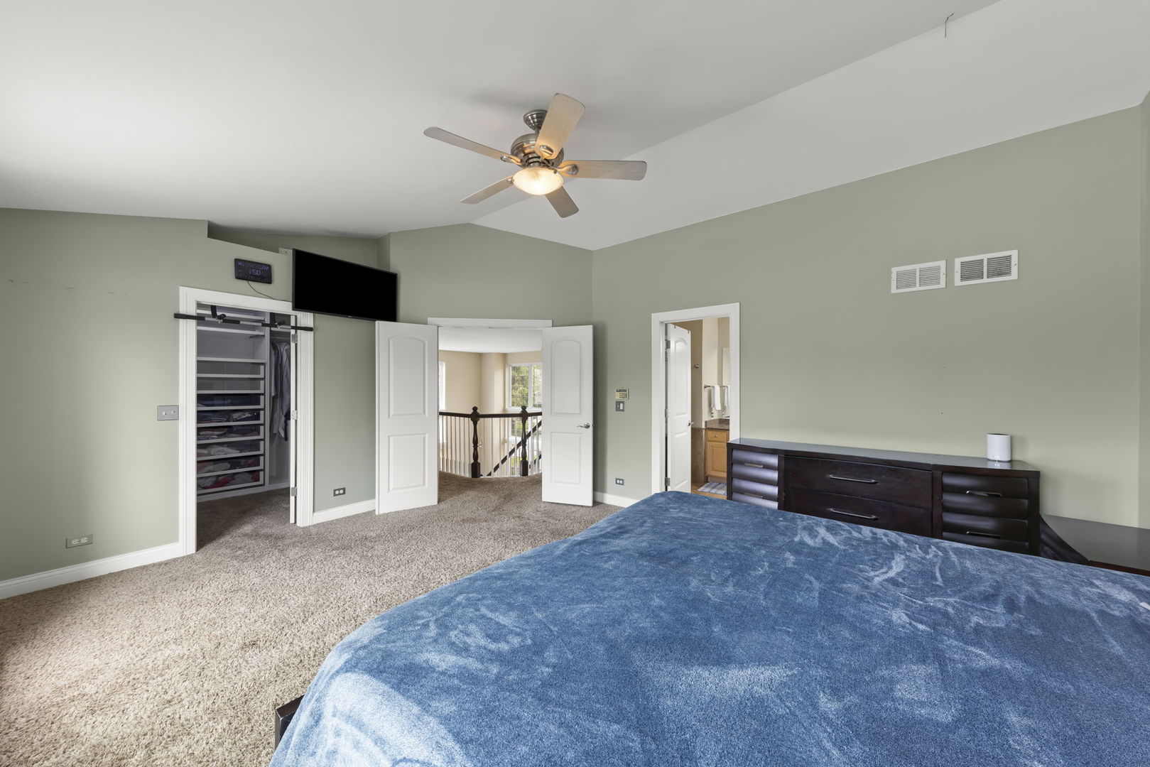 1462 Haversham Drive Aurora, IL 60502 - Photo 17 of 44 a spacious bedroom with a bed and a chandelier