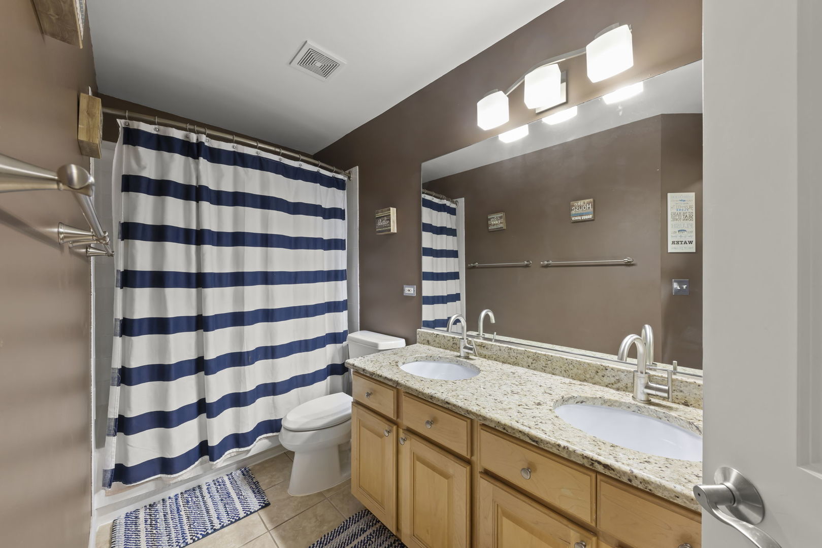 1462 Haversham Drive Aurora, IL 60502 - Photo 23 of 44 a bathroom with a sink a toilet a shower and a large mirror