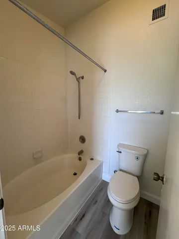 a bathroom with a bathtub and toilet