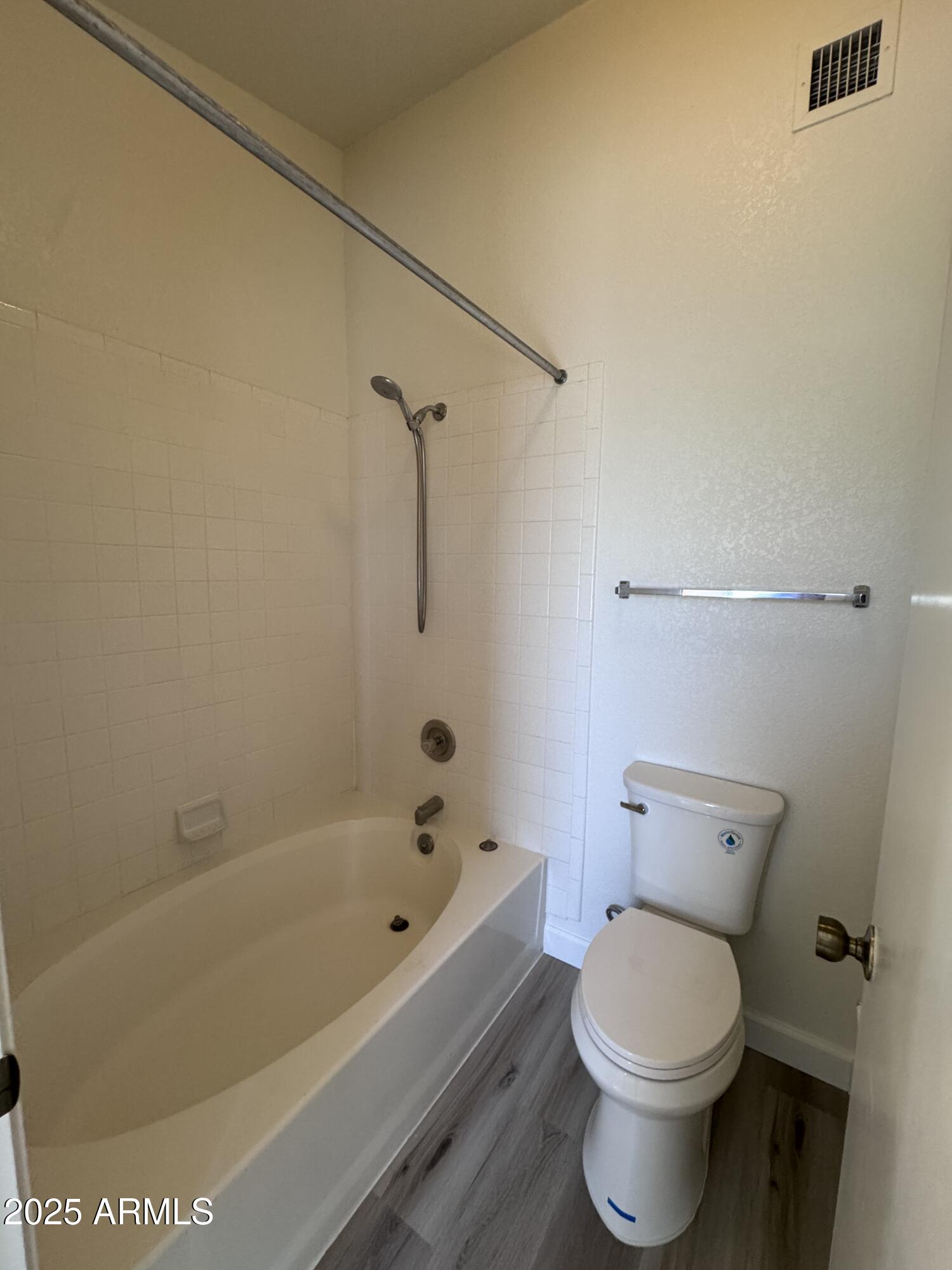8631 West Monte Vista Road Phoenix, AZ 85037 - Photo 16 of 26 a bathroom with a bathtub and toilet