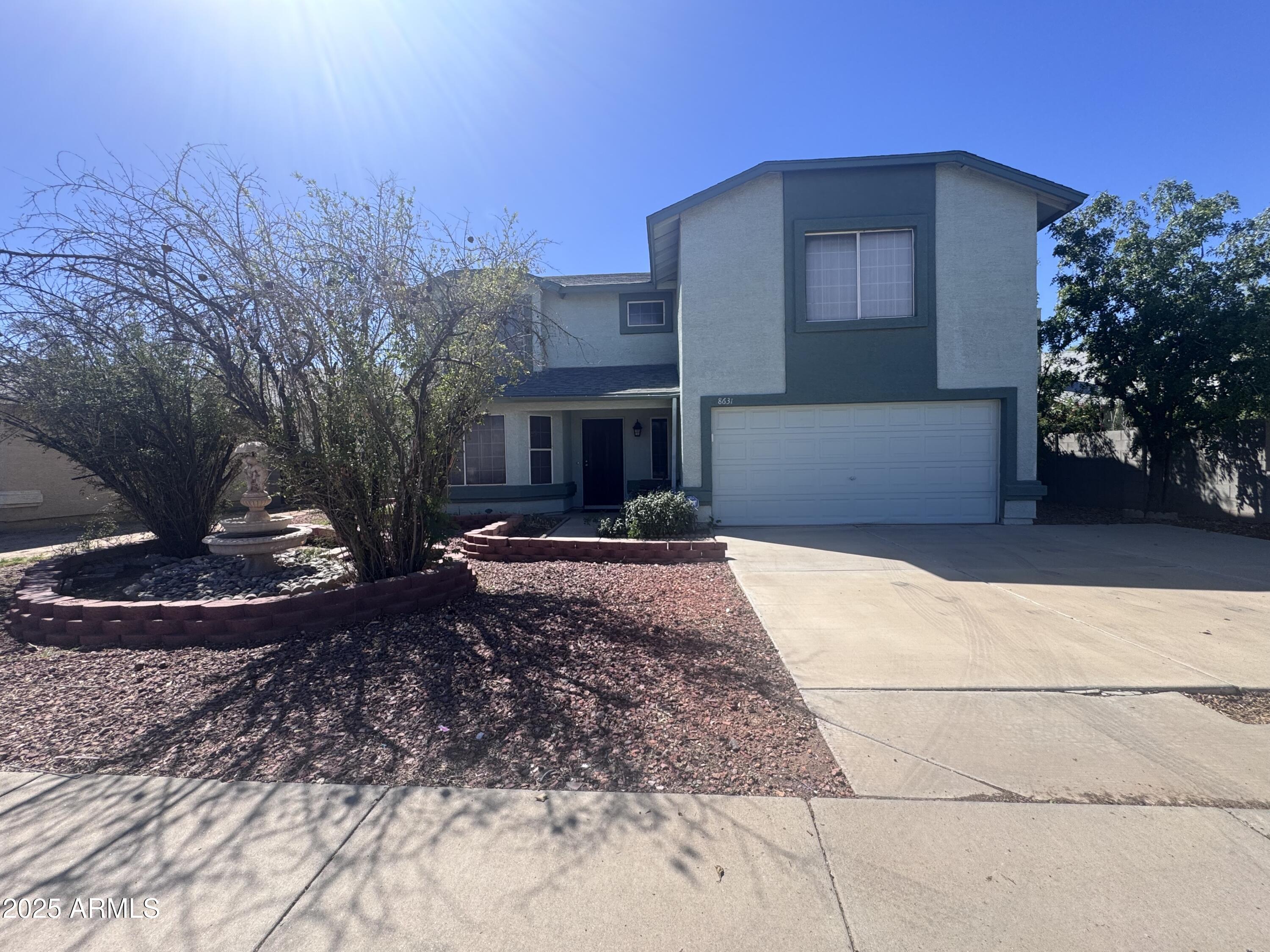 8631 West Monte Vista Road Phoenix, AZ 85037 - Photo 2 of 26 a front view of a house with garden