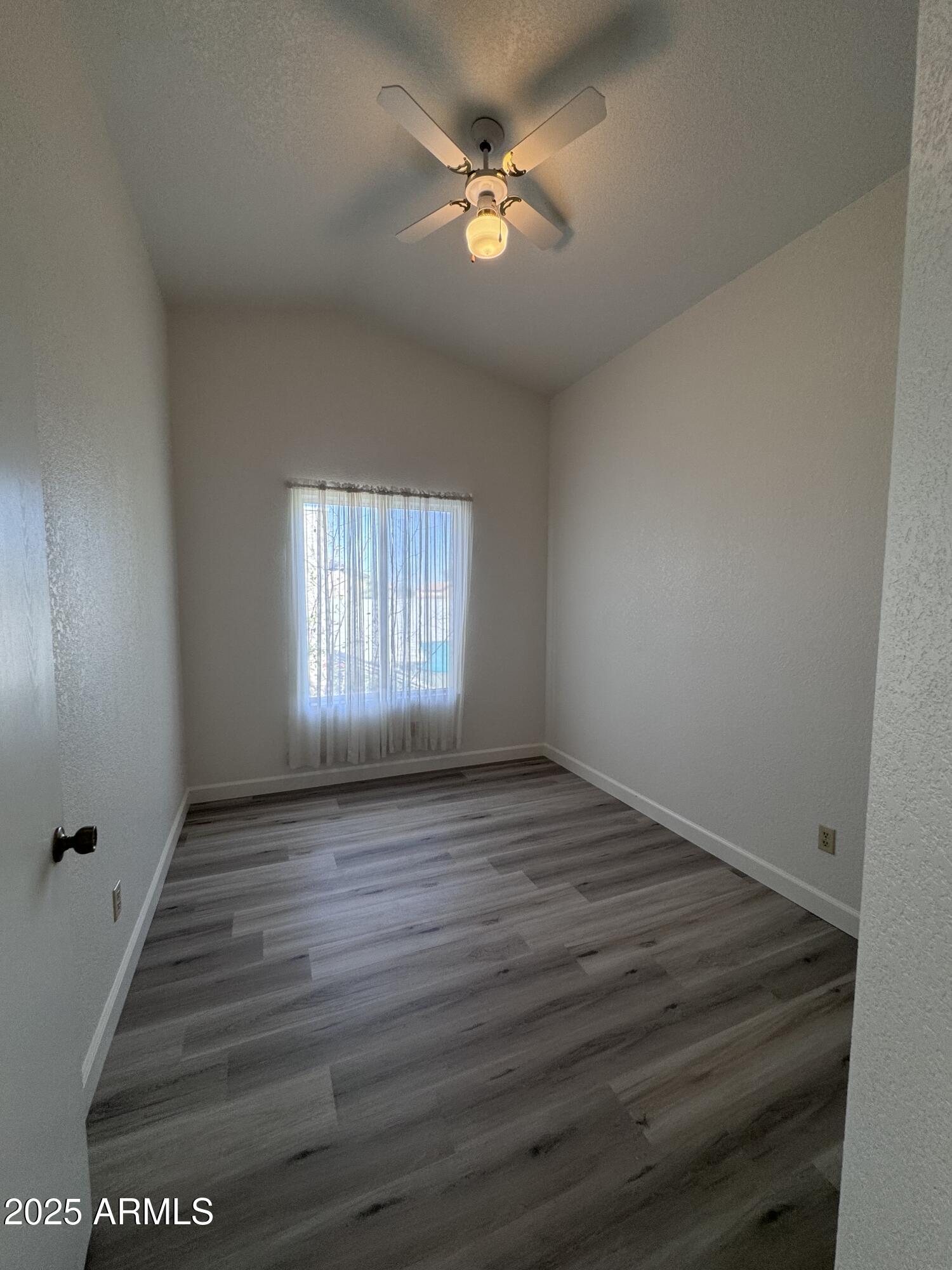 8631 West Monte Vista Road Phoenix, AZ 85037 - Photo 21 of 26 wooden floor in an empty room with a window
