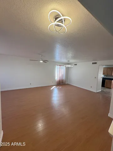 a view of room and hall with wooden floor