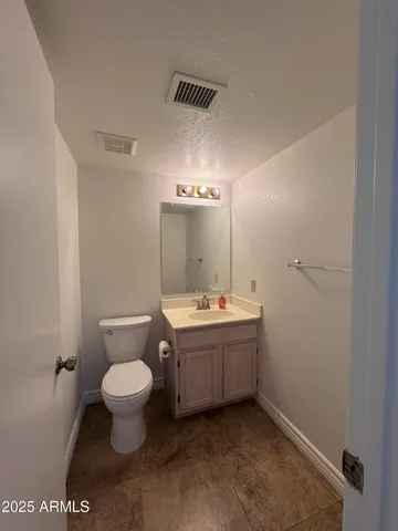a bathroom with a sink toilet and mirror