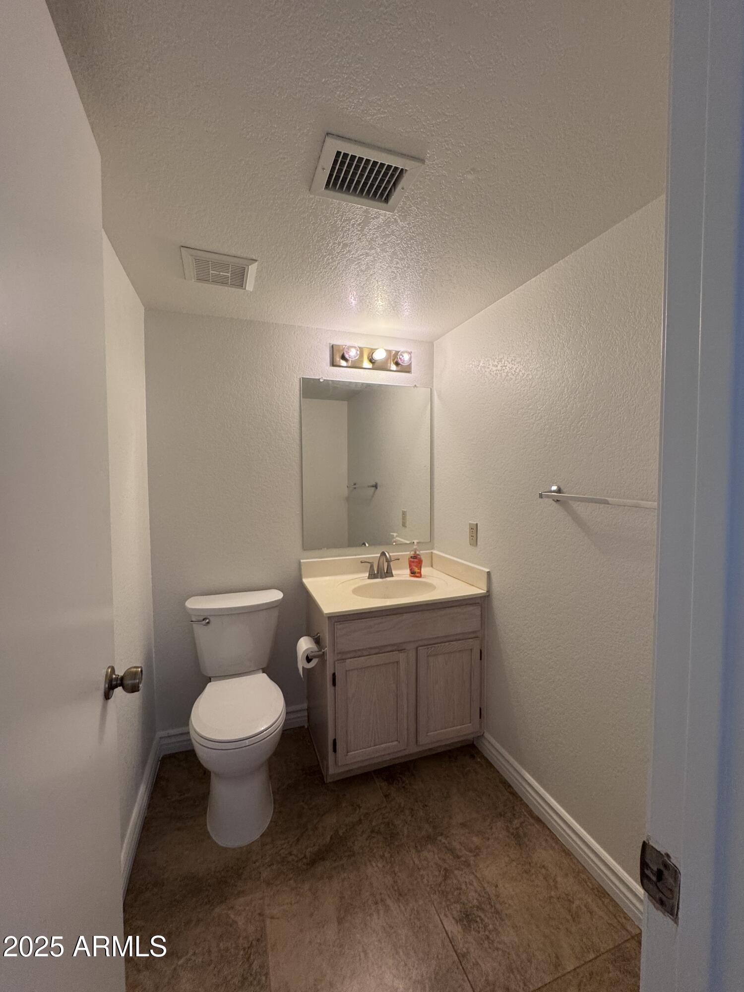 8631 West Monte Vista Road Phoenix, AZ 85037 - Photo 10 of 26 a bathroom with a sink toilet and mirror
