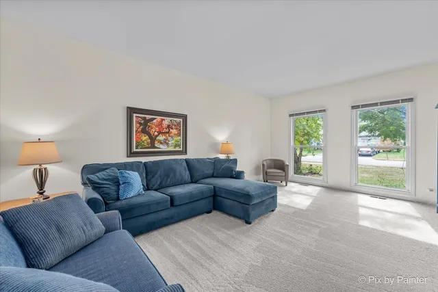 a dining room with furniture a chandelier and wooden floor