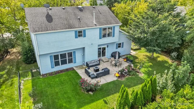 an aerial view of residential houses with outdoor space and swimming pool