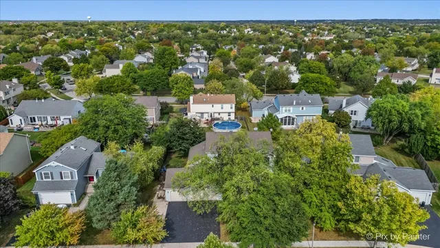 an aerial view of a city with lots of residential buildings and mountain view in back