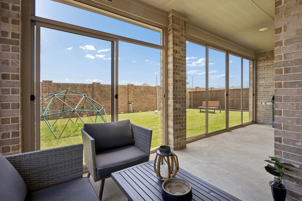 425 Breeds Hl Road Little Elm, TX 75068 - Photo 29 of 38 a living room with furniture and a floor to ceiling window