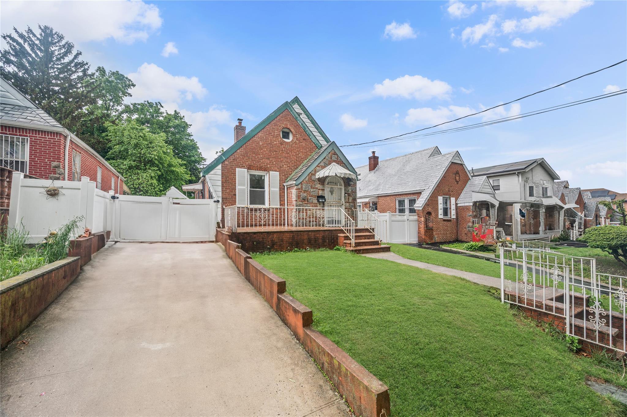 82-72 164th Place Queens, NY 11432 - Photo 1 of 1 a view of a house next to a yard with plants and a large tree