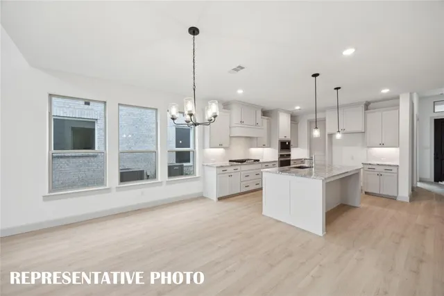 a view of a room with wooden floor fireplace and windows