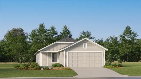 a front view of a house with a yard and trees