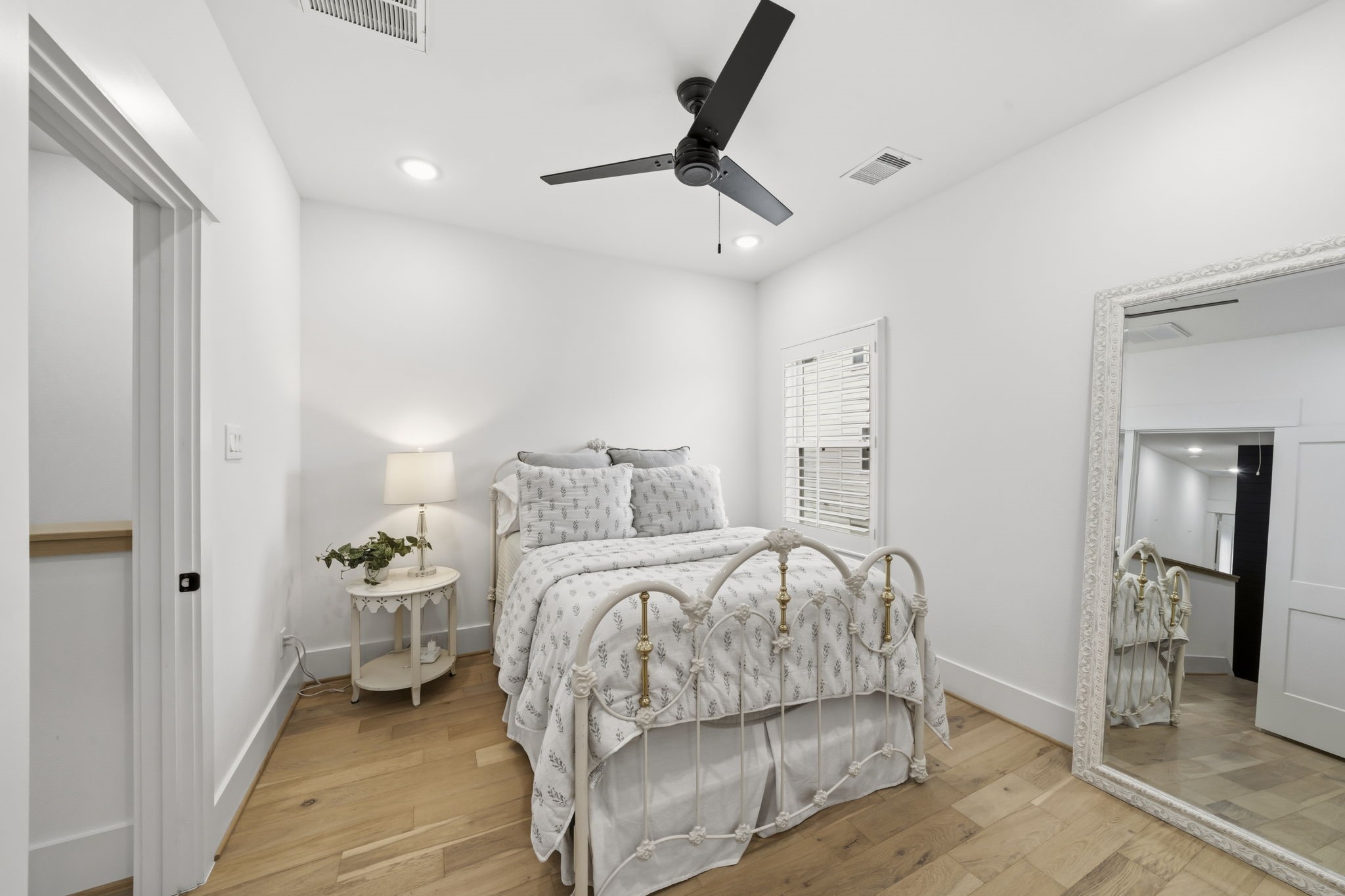 9018 Wellspring Drive Houston, TX 77080 - Photo 16 of 25 Spacious and bright, this bedroom easily accommodates a large suite of furniture. The high ceilings and recessed lighting enhance the open feel, creating a tranquil retreat at the end of the day.