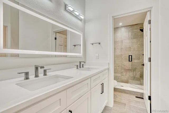 a bathroom with a sink and a mirror with bathtub