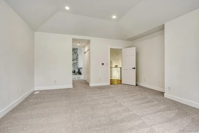 an empty room with closet and wooden door