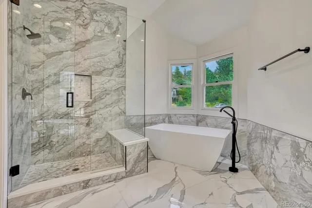 a bathroom with a bathtub and shower