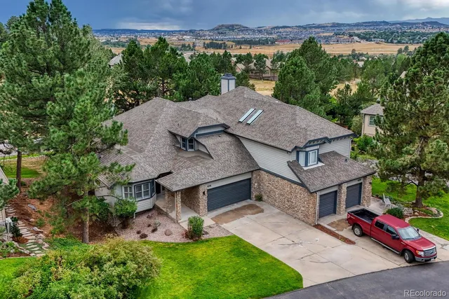 an aerial view of a house with garden space and street view
