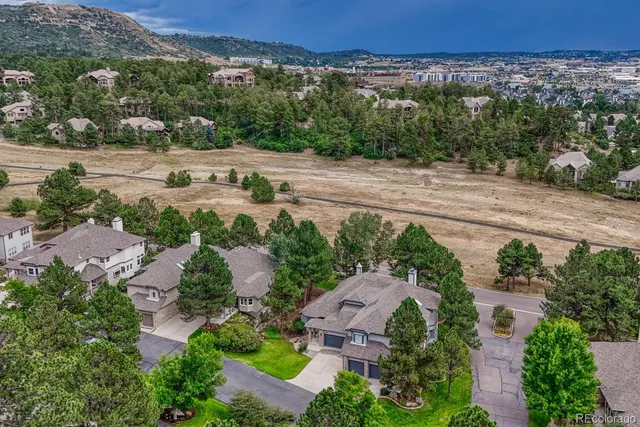 an aerial view of a house with a yard