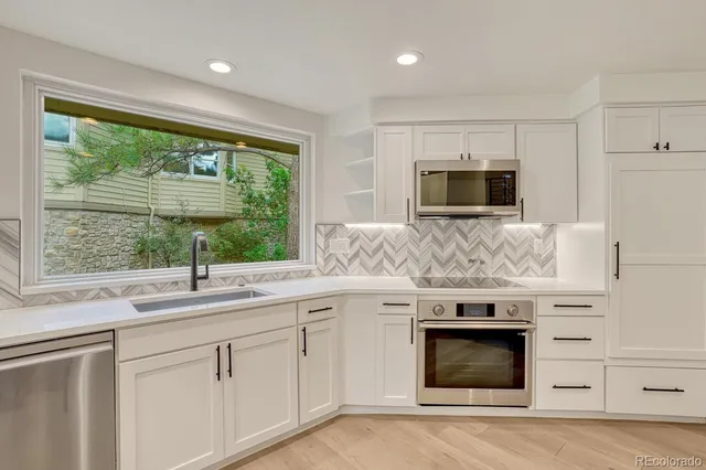 a kitchen with a sink stove and microwave
