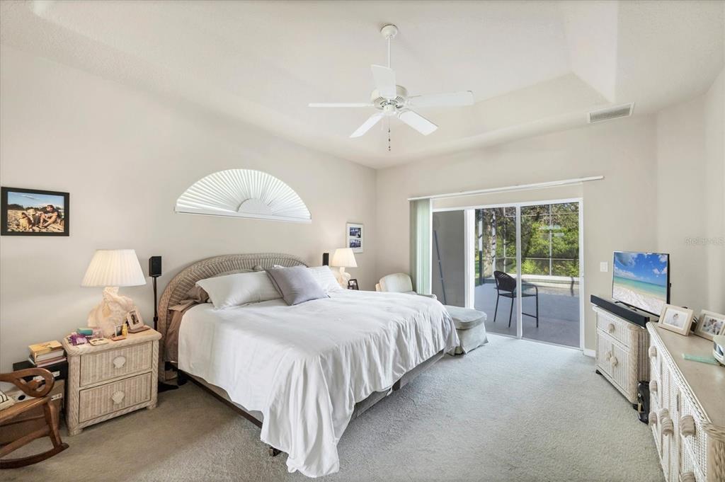 4 Windward Way Placida, FL 33946 - Photo 25 of 39 a bedroom with a bed and a flat tv screen on dresser