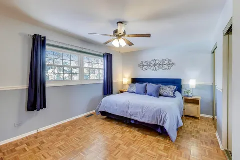 a bedroom with a large bed and a window