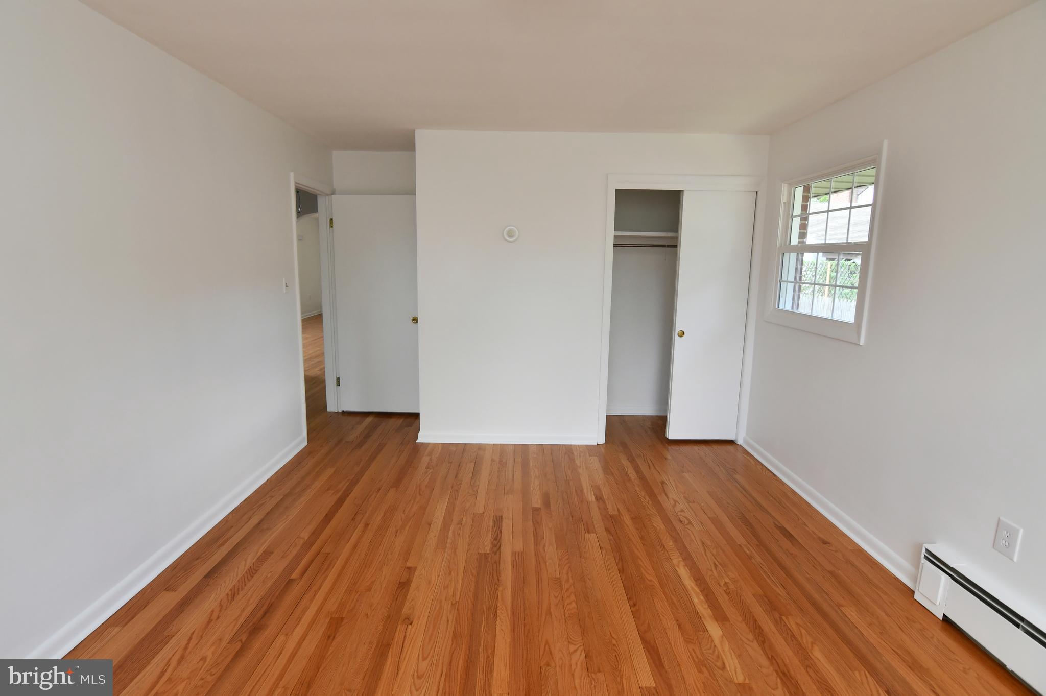 437 Beechcroft Road Winchester, VA 22601 - Photo 30 of 52 a view of an empty room with wooden floor and a window