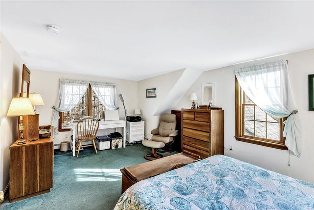 a bedroom with furniture and a window