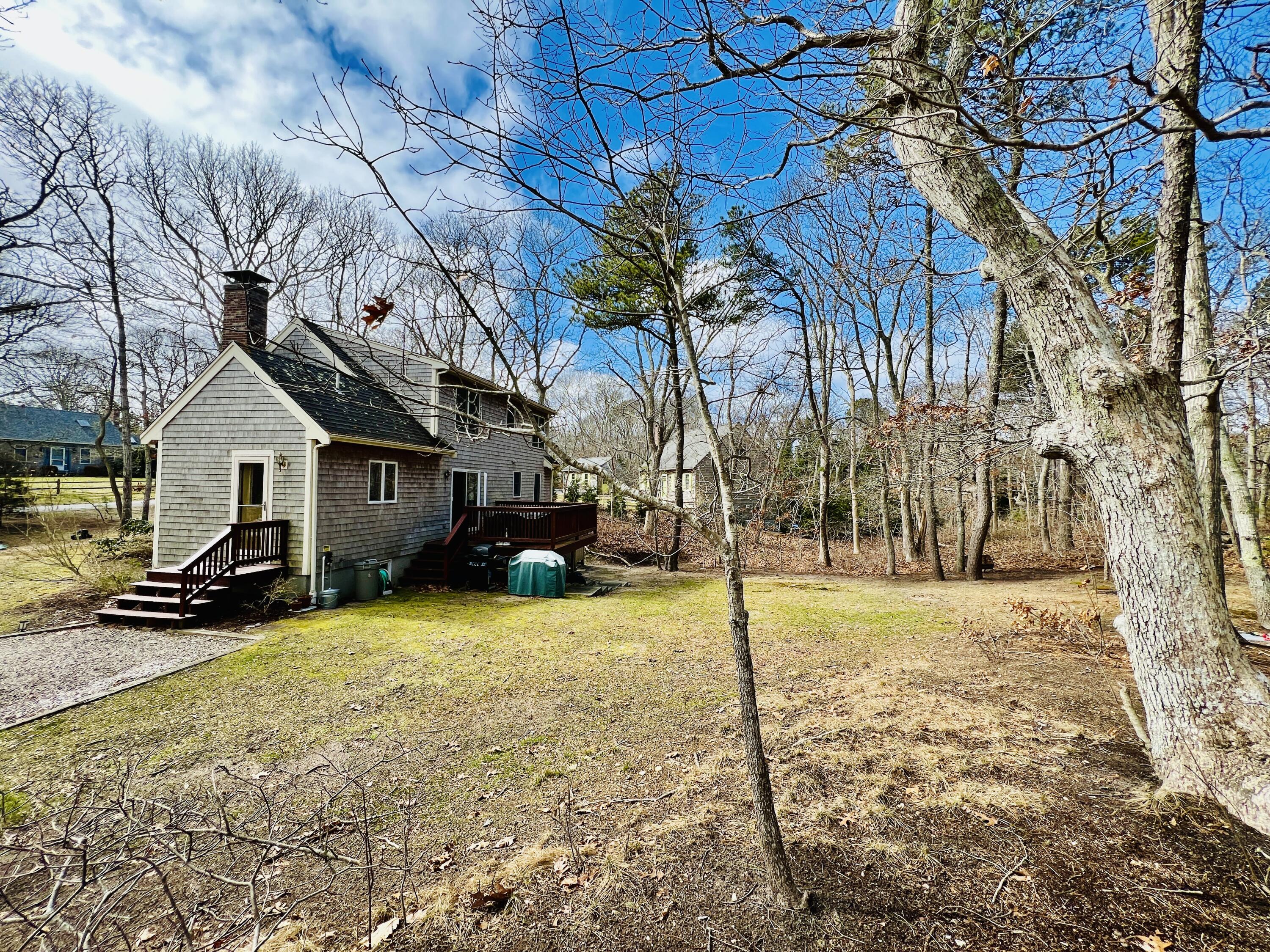 14 Fallon Road Eastham, MA 02642 - Photo 23 of 27 a view of a white house with a yard covered in snow