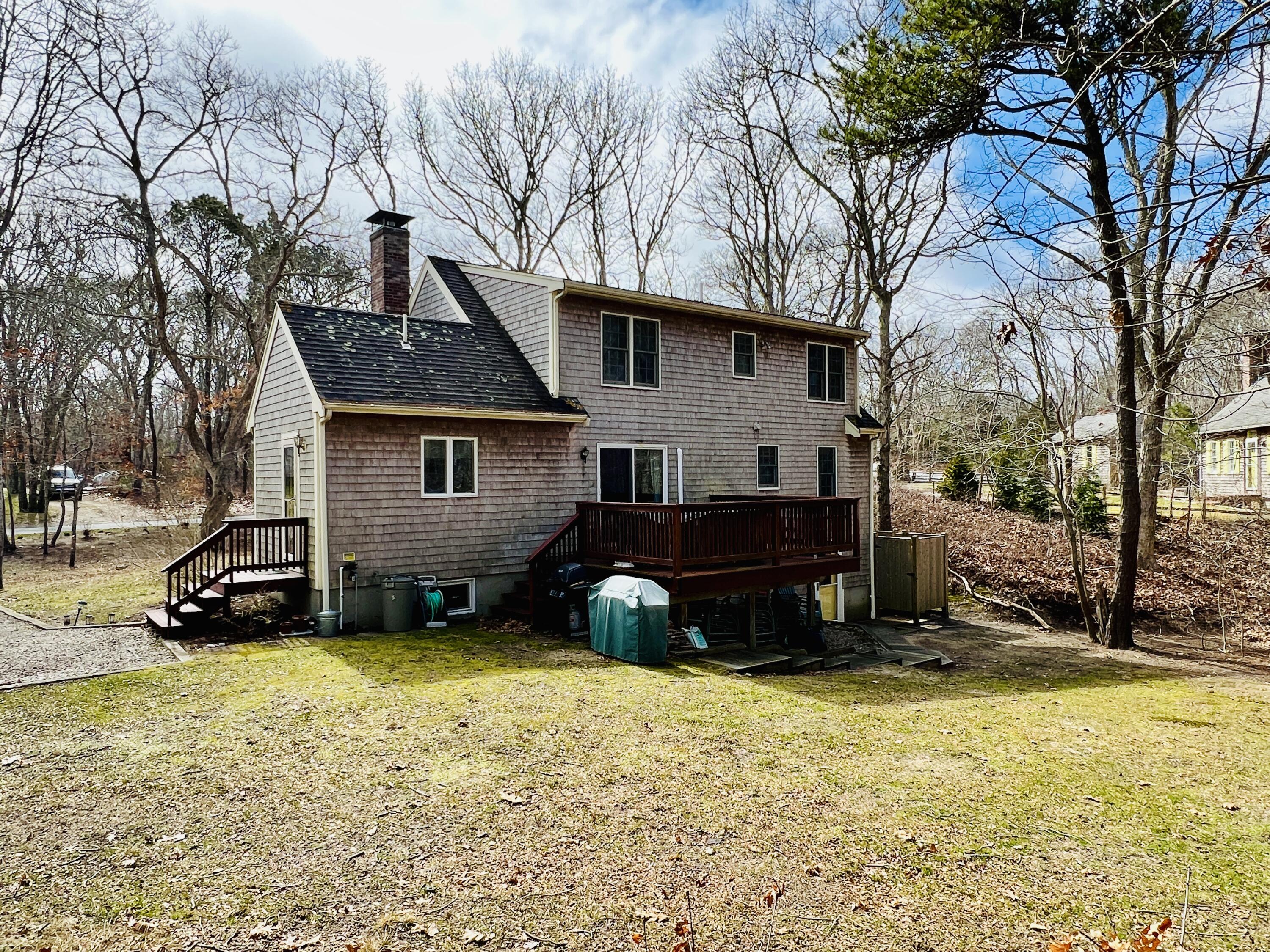 14 Fallon Road Eastham, MA 02642 - Photo 24 of 27 a view of a house with a yard covered with snow in the front