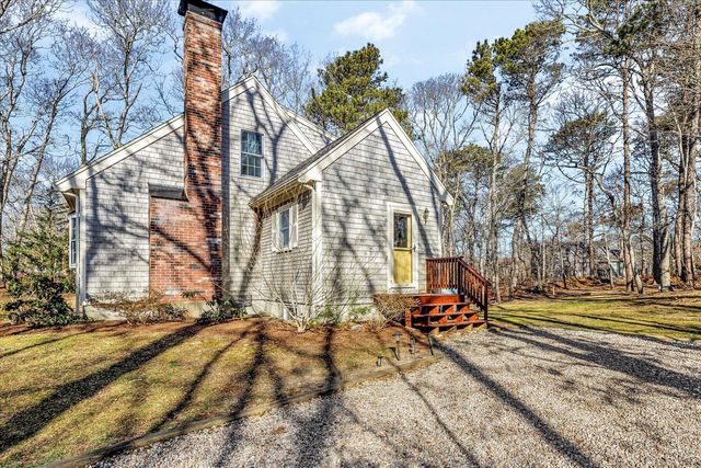 a view of backyard with a table and chairs