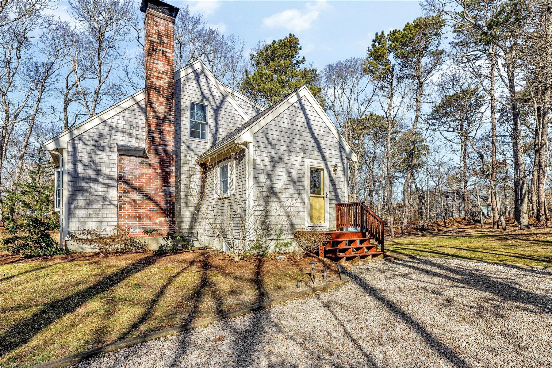14 Fallon Road Eastham, MA 02642 - Photo 3 of 27 a view of backyard with a table and chairs